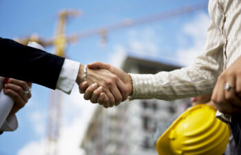 Two architects handshaking, selective focus
