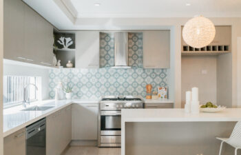 Kitchen design with a statement island bench and a kitchen sink window.